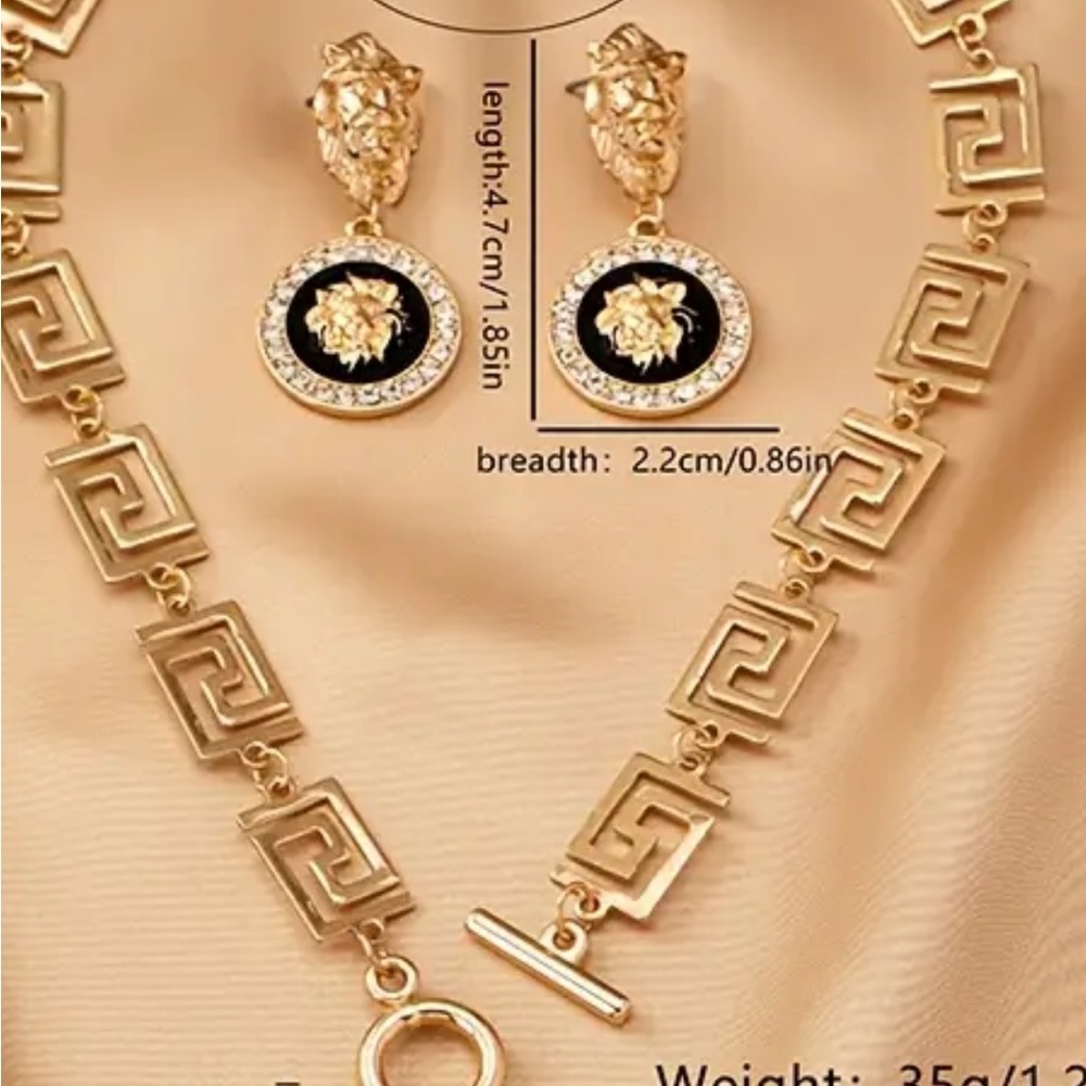 Lion head with rhinestones around itGold & Black Geometric Necklace/ Earring Set